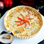 red peppers quiche on a cake stand.