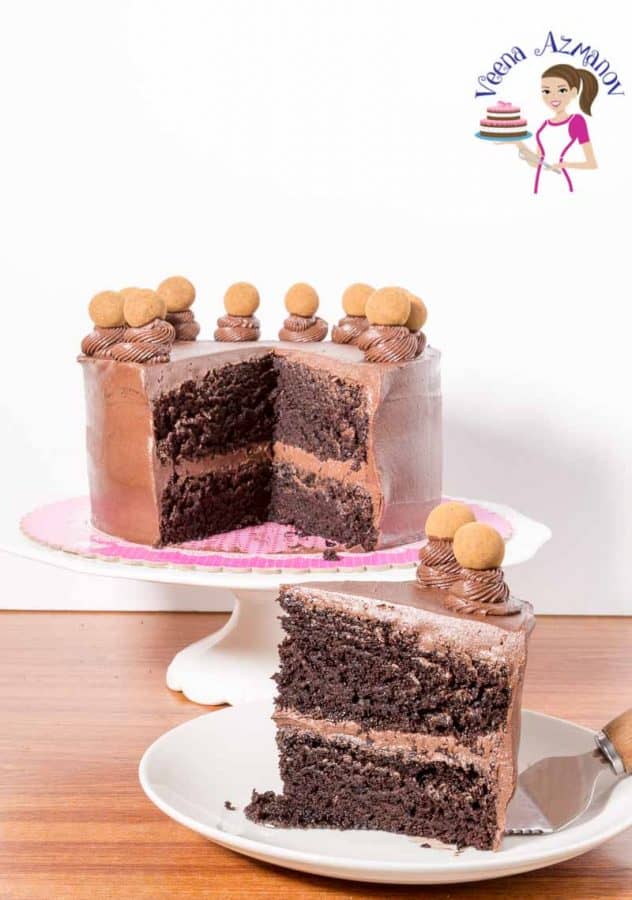 A sliced chocolate cake on a cake stand.
