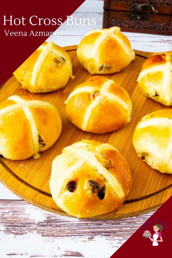 Hot cross buns on a wooden tray.
