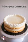 A mascarpone cream cake on a cake stand.
