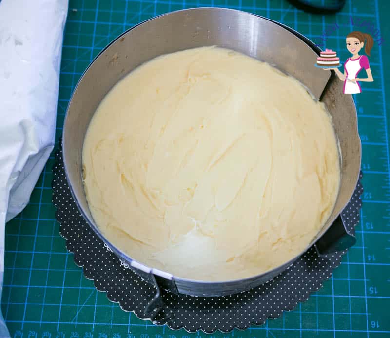 Making a cream cake in a cake ring.