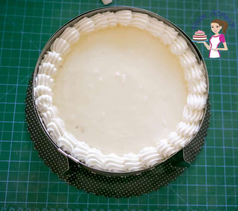 A top view of a mascarpone cream cake in a cake ring.