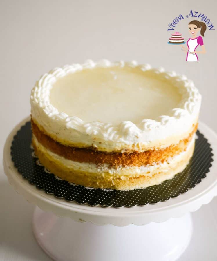 A mascarpone cream cake on a cake stand.