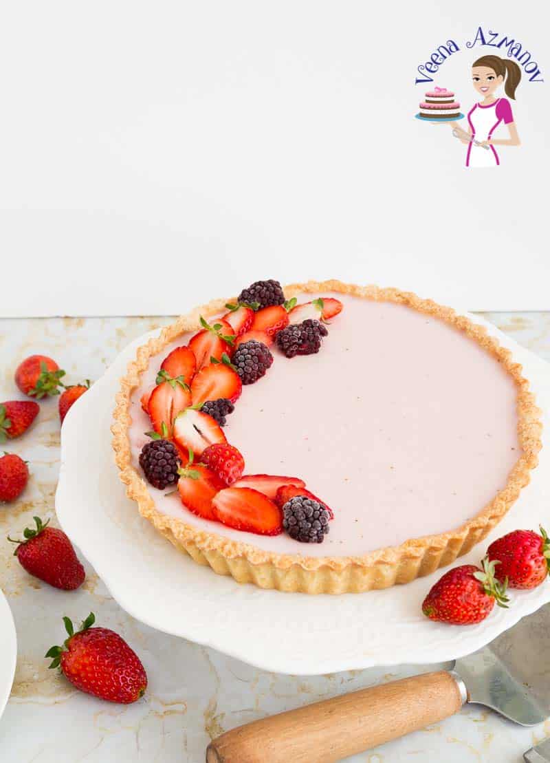 A strawberry Panna cotta tart on a cake stand.