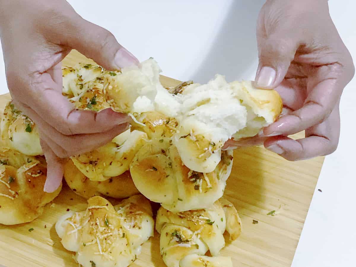 Breaking the garlic butter rolls.
