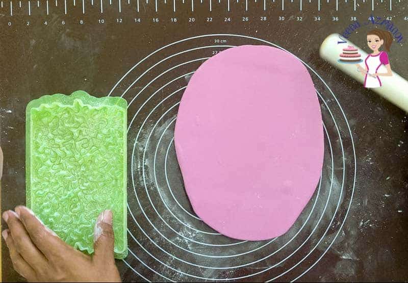 Pink fondant spread on a table.