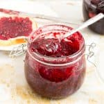 A jar with raspberry jam recipe.