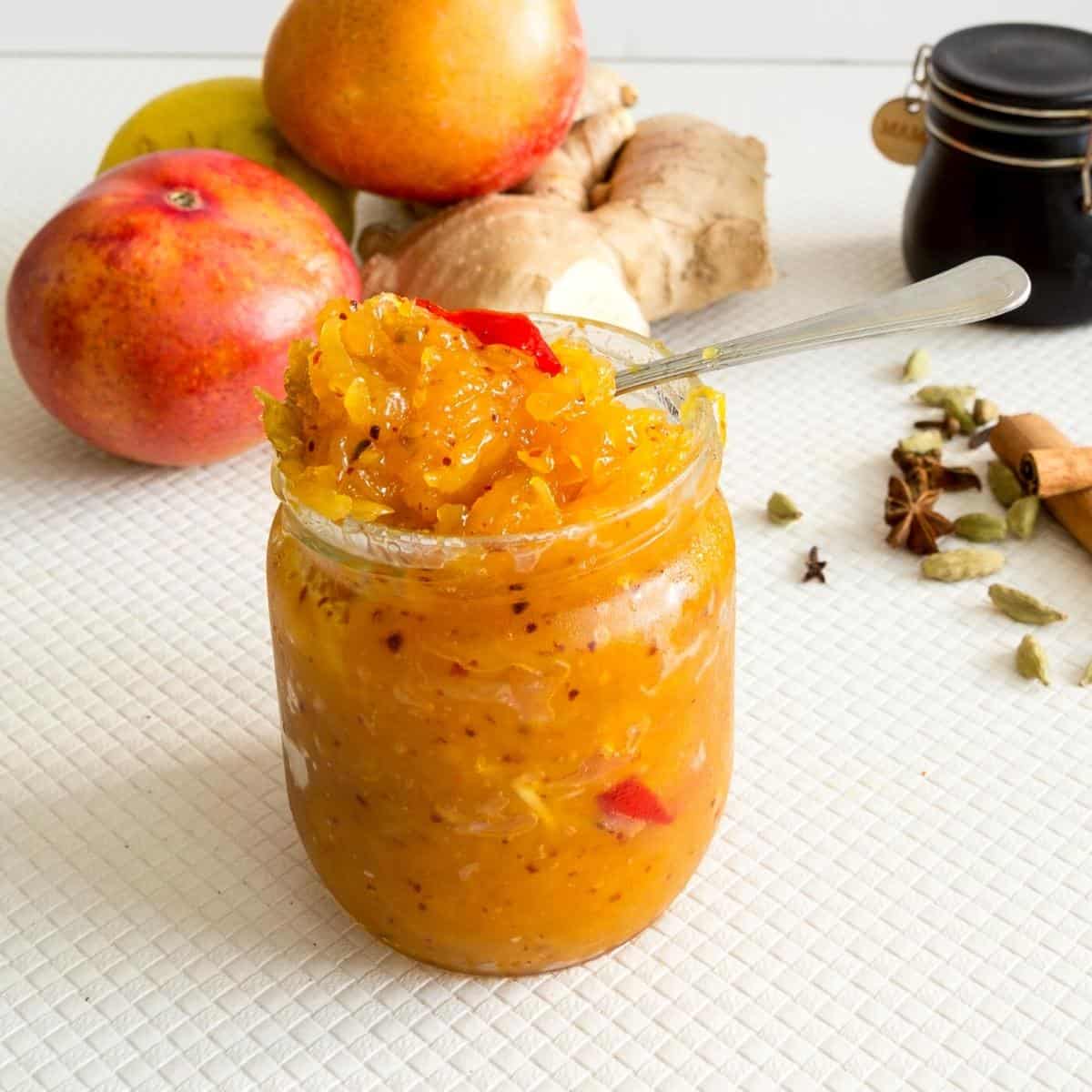 Mango chutney in a mason jar with spoon.
