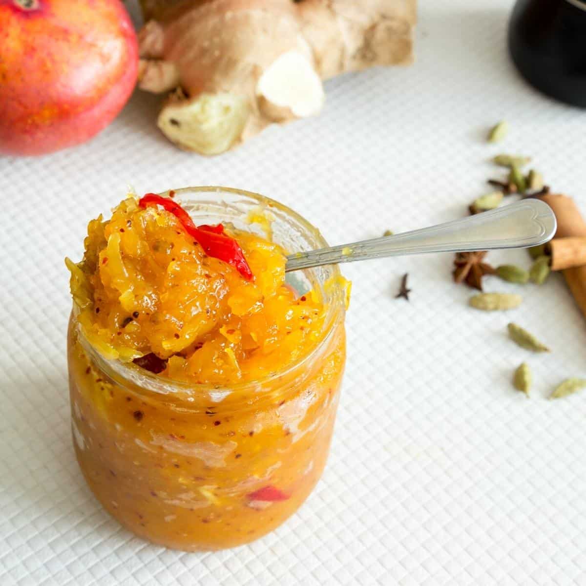 Mango chutney in a spoon and jar.