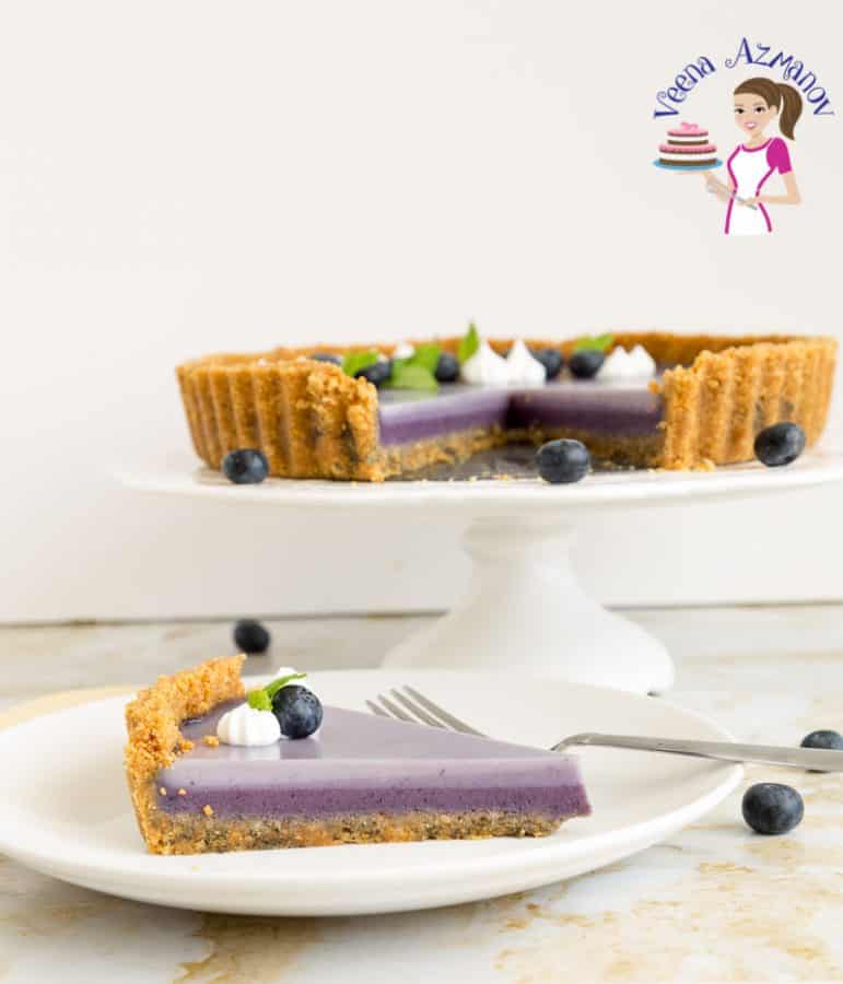 A slice of blueberry panna cotta tart on a plate.