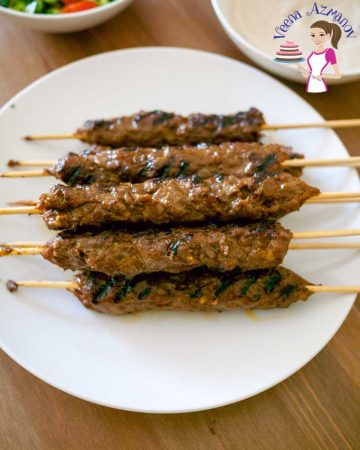 A stack of kebab skewers on a plate.