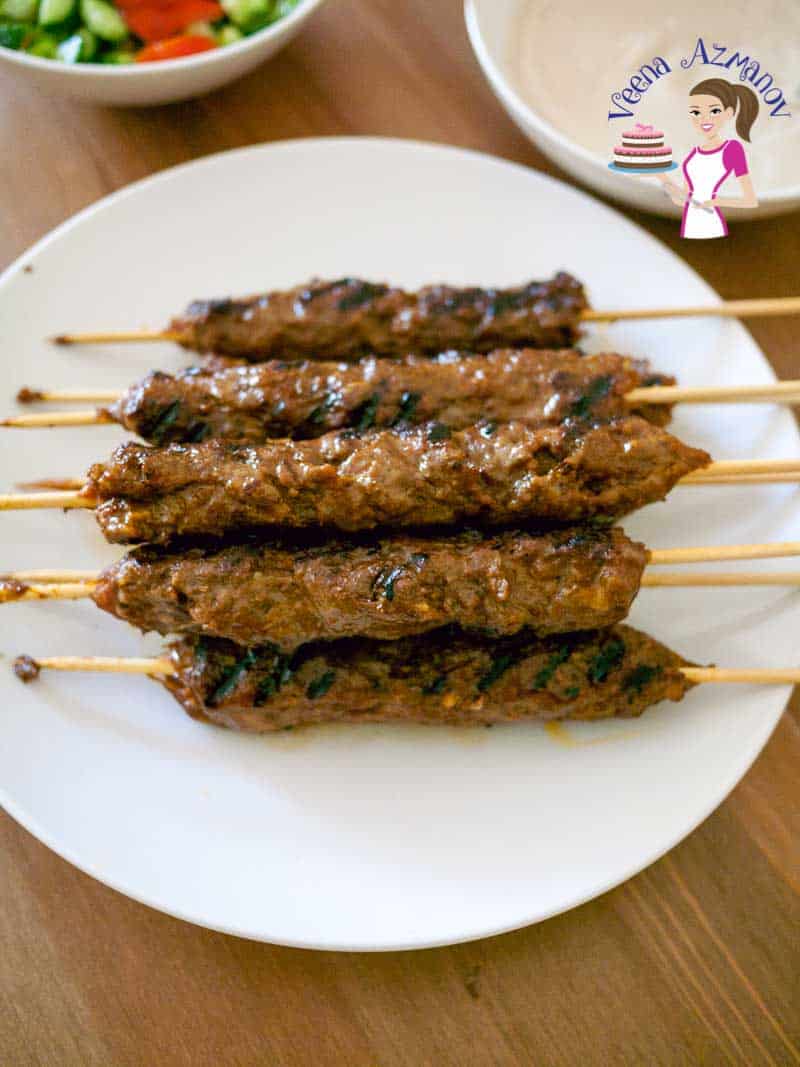 A stack of kebab skewers on a plate.