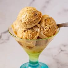 4 scoops of creamy dulce ice cream in a glass.
