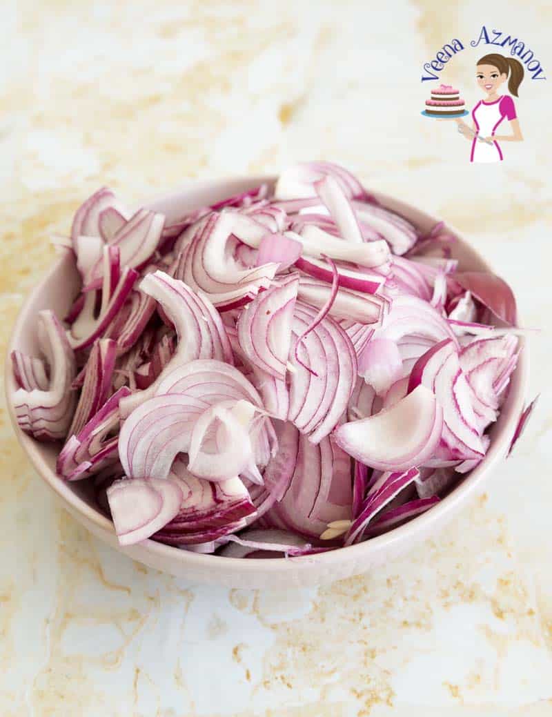 Sliced onions in a bowl ready to be caramelized for rogan josh