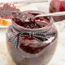 Mason jar with jam and spoon.