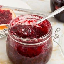 A mason jar with raspberry no pectin jam.