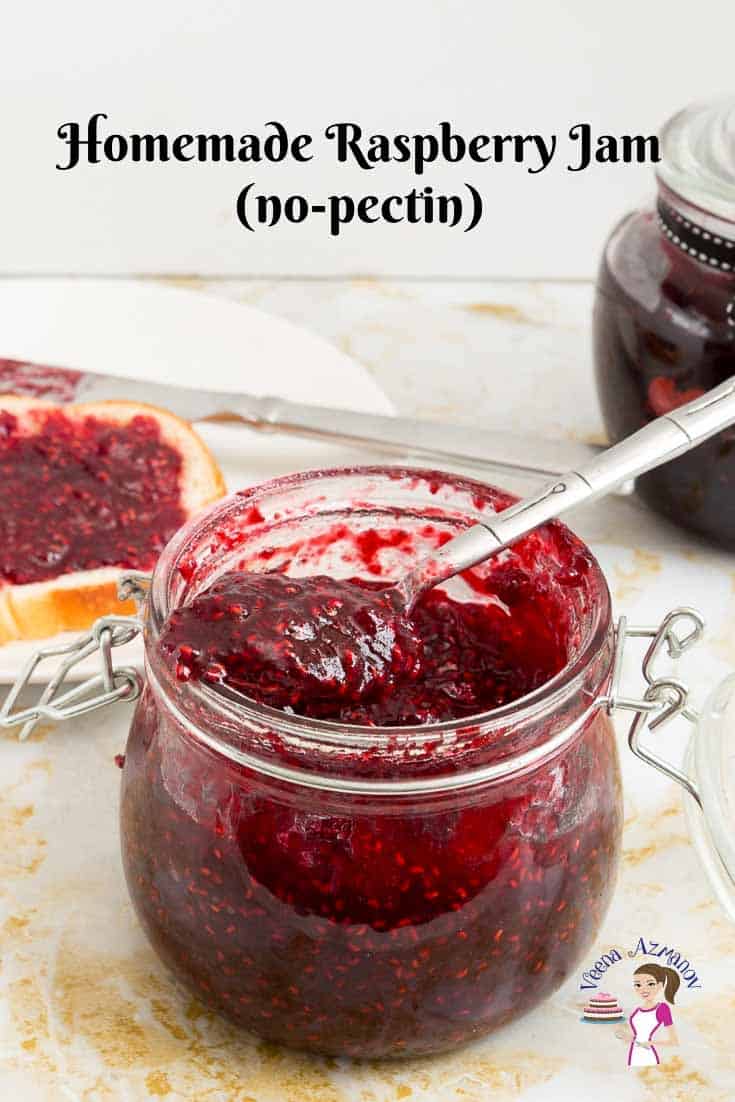 A jar of Raspberry jam with a spoon.