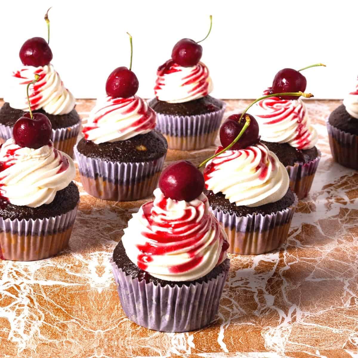 Frosted chocolate cupcake with cherry filling.