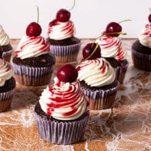 Frosted cupcake with cherry.