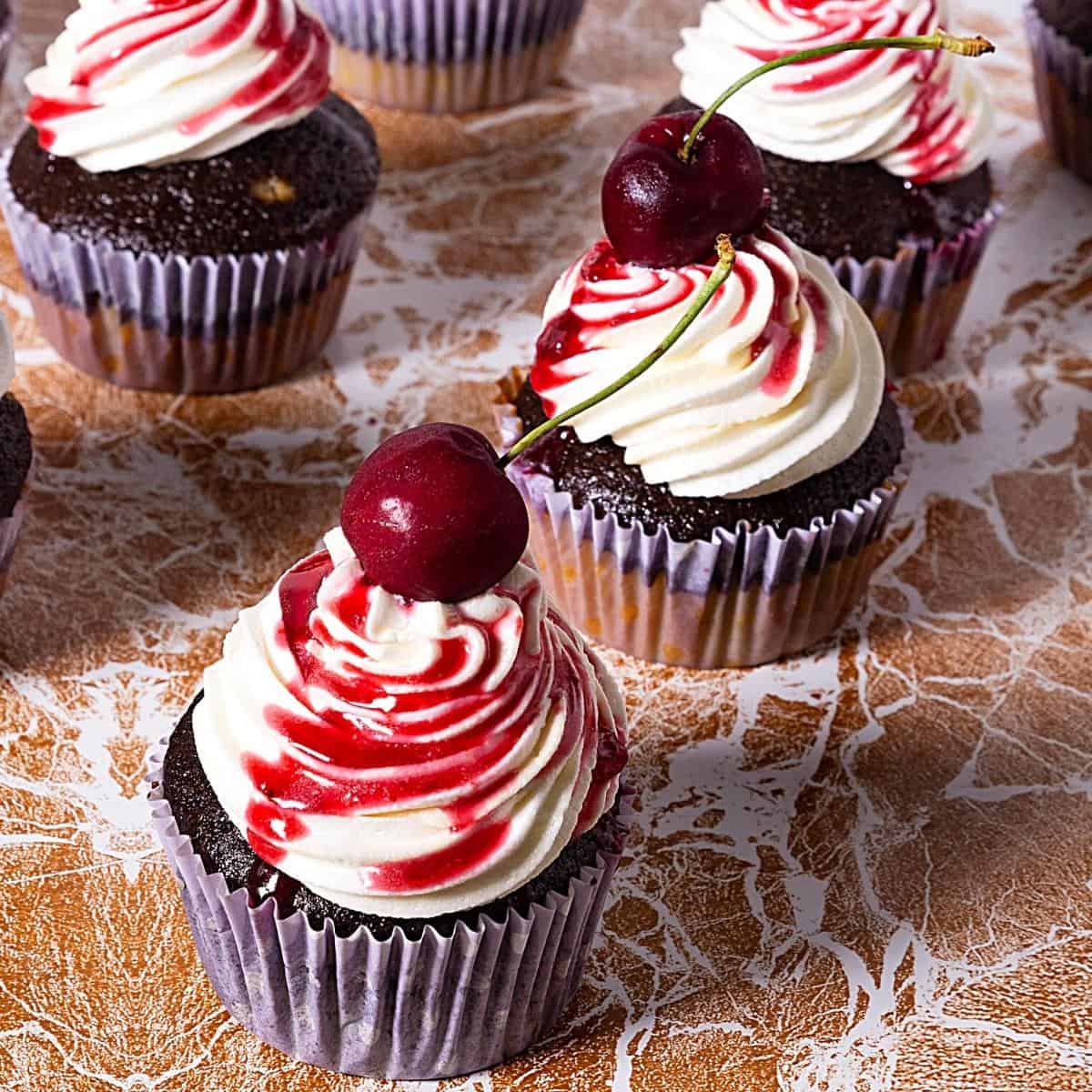 Frosted cupcake with cherry filling.