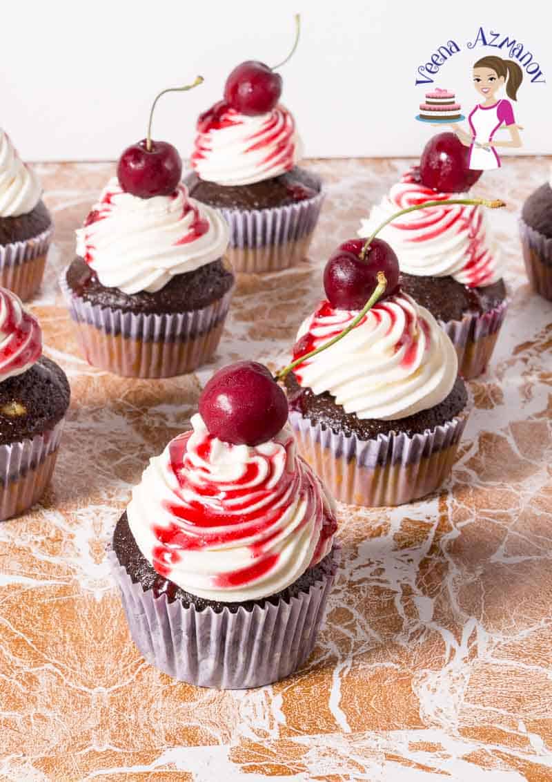 Chocolate cherry cupcakes on a table.