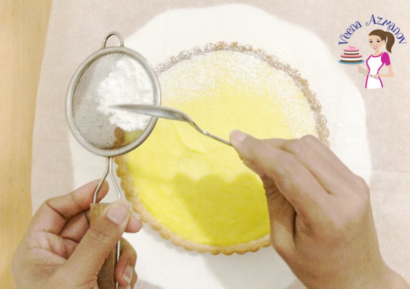 Dusting the lemon curd tart with powdered sugar
