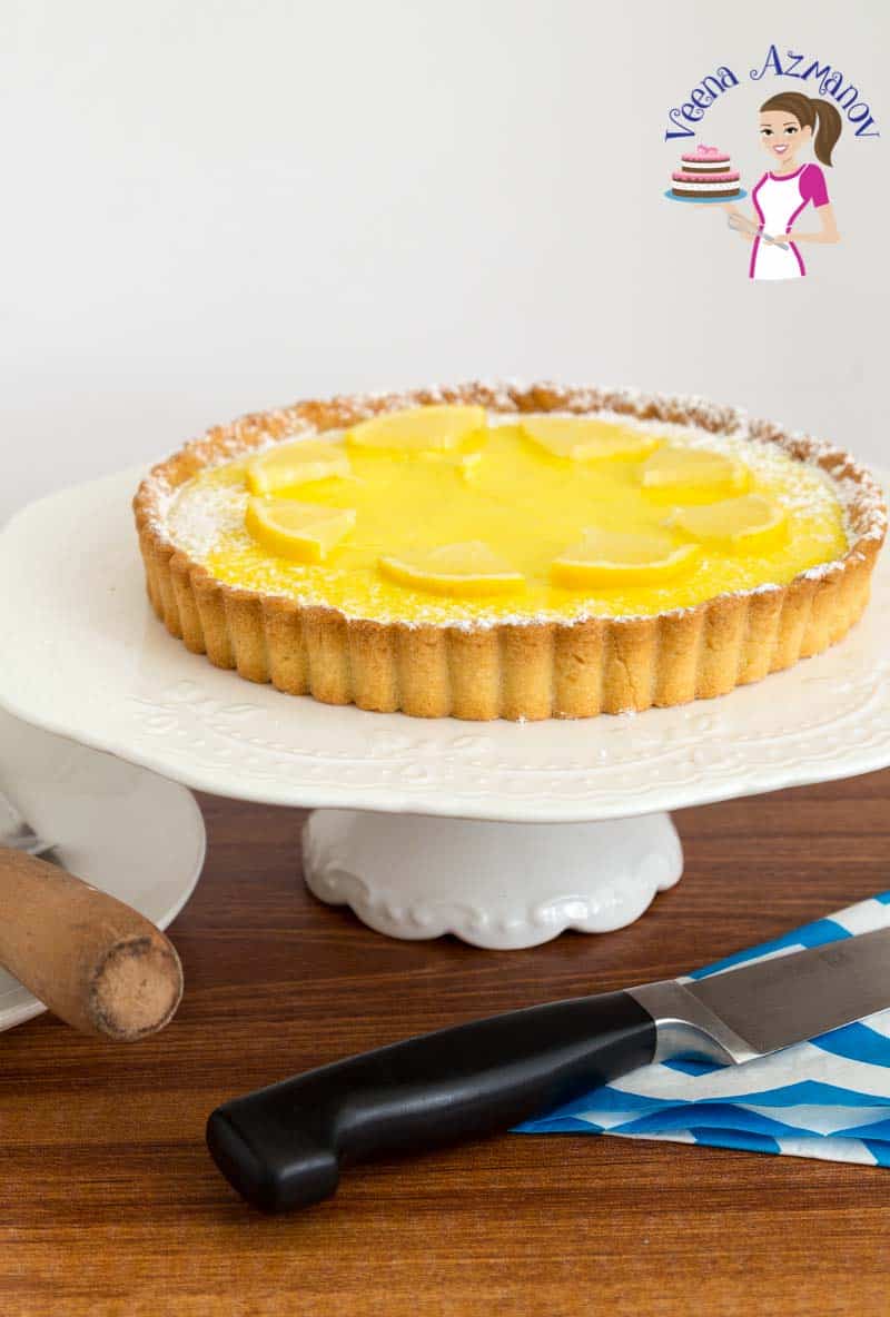 A lemon curd tart on a cake stand.
