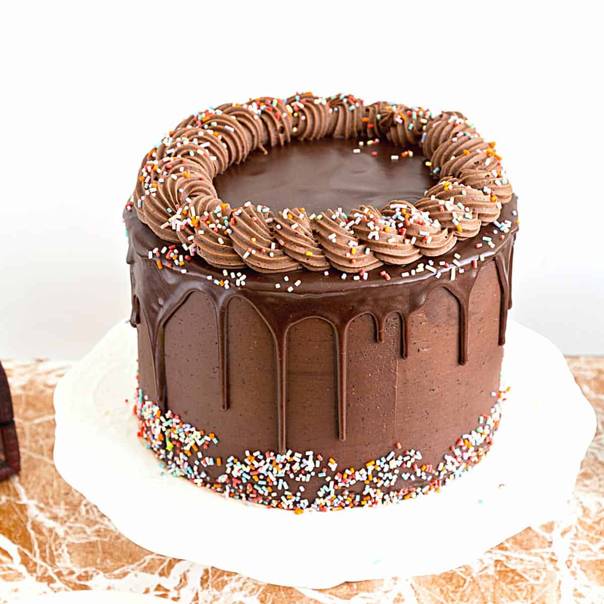 A chocolate cake on cake stand.