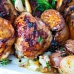 A golden brown chicken in sheet pan.