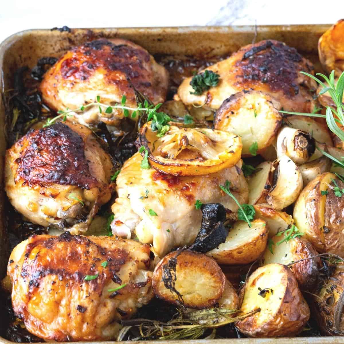 A sheet pan with roasted chicken.