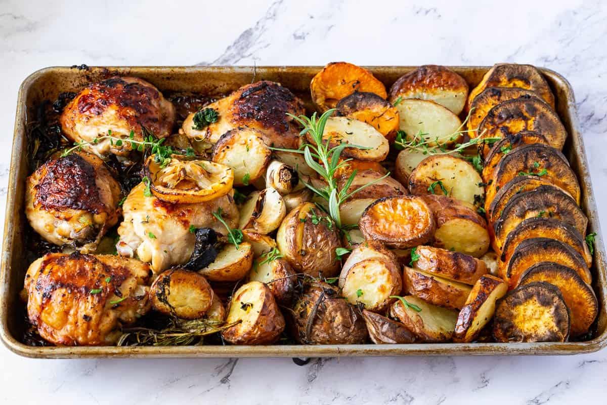 A sheet pan with lemon roast chicken and veggies.