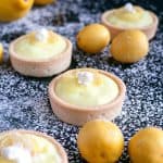 Tartlets dusted with powdered sugar.