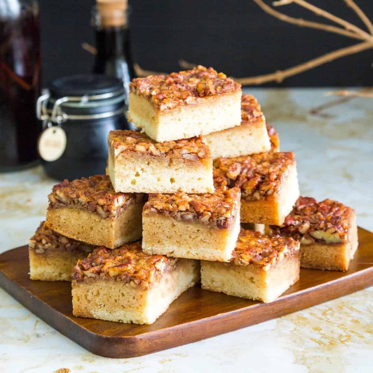 Blondies stacked on a wooden board.