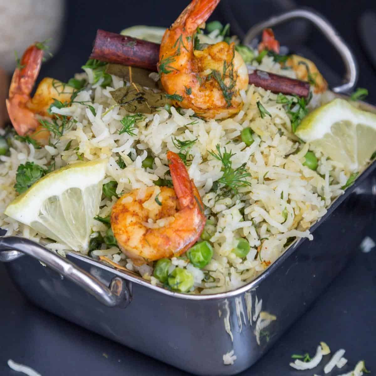A skillet with shrimps and rice.