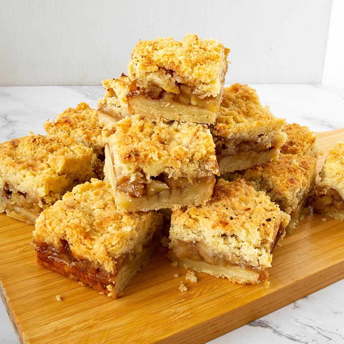 A wooden board with apple pie bars.