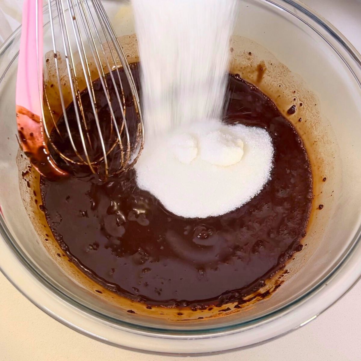 A glass bowl with death by chocolate cake progress pictures.