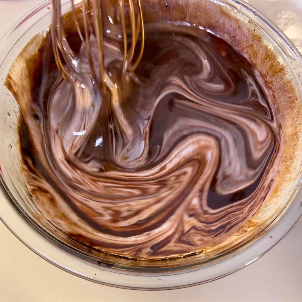 A glass bowl chocolate cake batter.