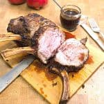 A sliced standing rib on a wooden board.
