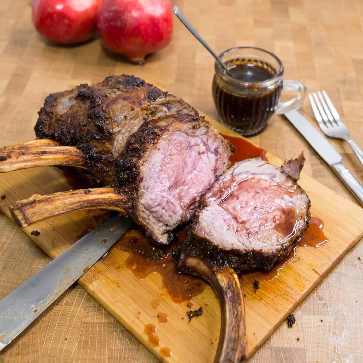 Sliced roasted rib roast on a wooden board.