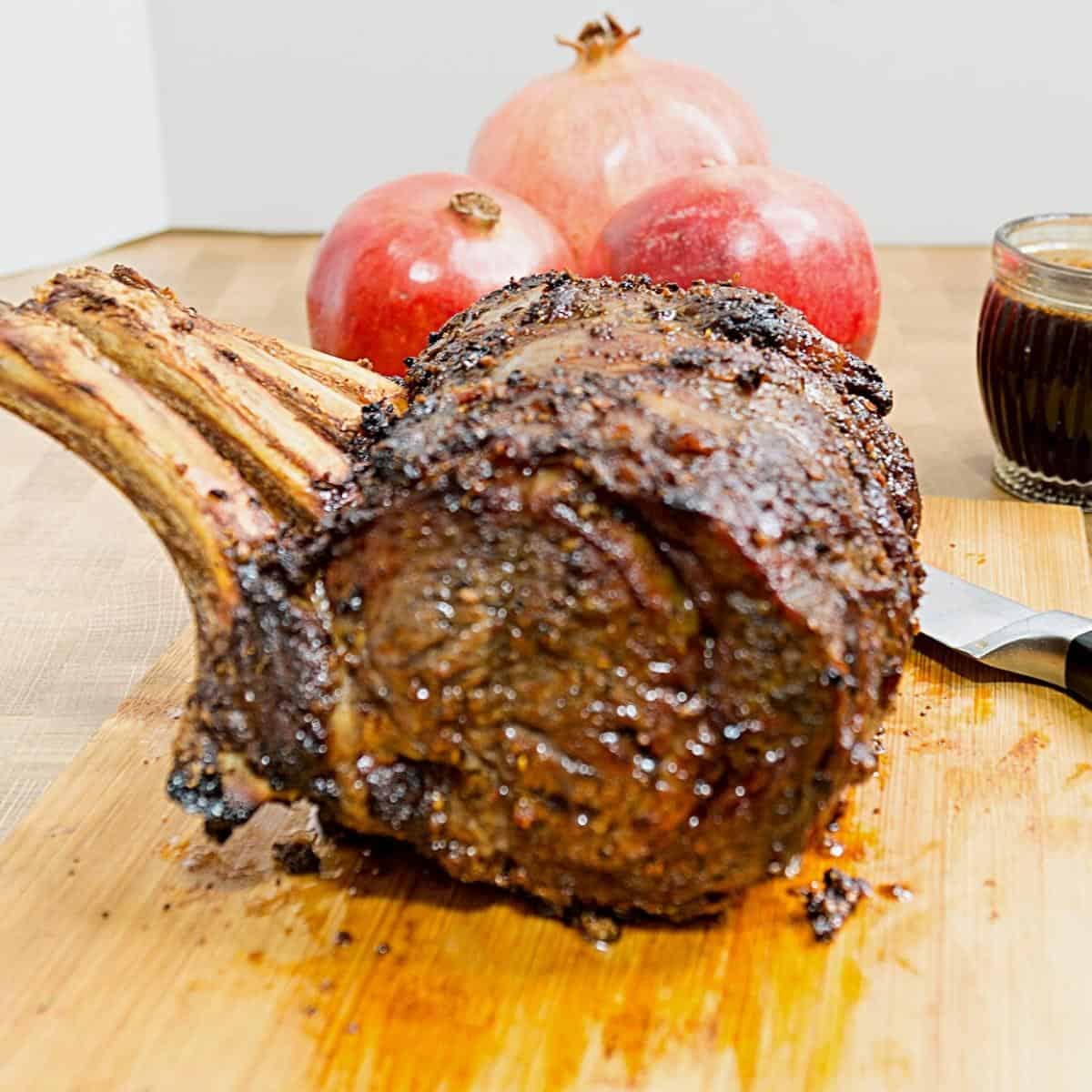 A roasted prime rib on a wooden board.