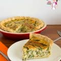 A slice of asparagus and leek quiche on a plate.