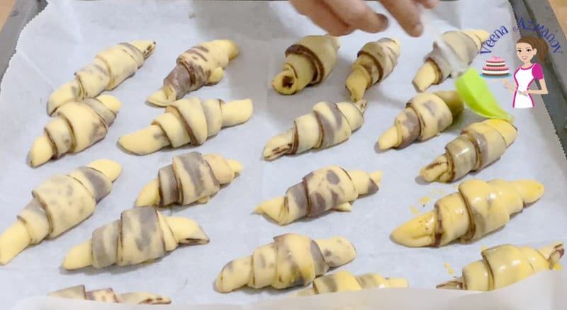 Brush the chocolate rugelach on the baking tray