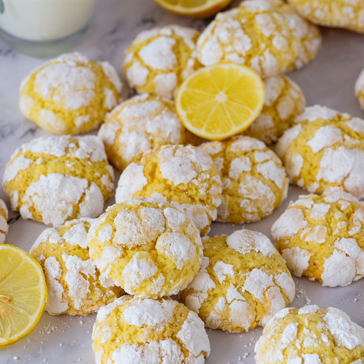 A stack of yellow lemon cookies on the table.