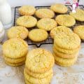 A stack of lemon crinkle cookies on a table.