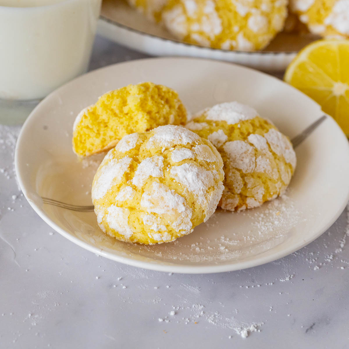 A saucer with lemon crinkle cookies.