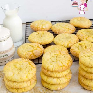 A stack of lemon crinkle cookies on a table.
