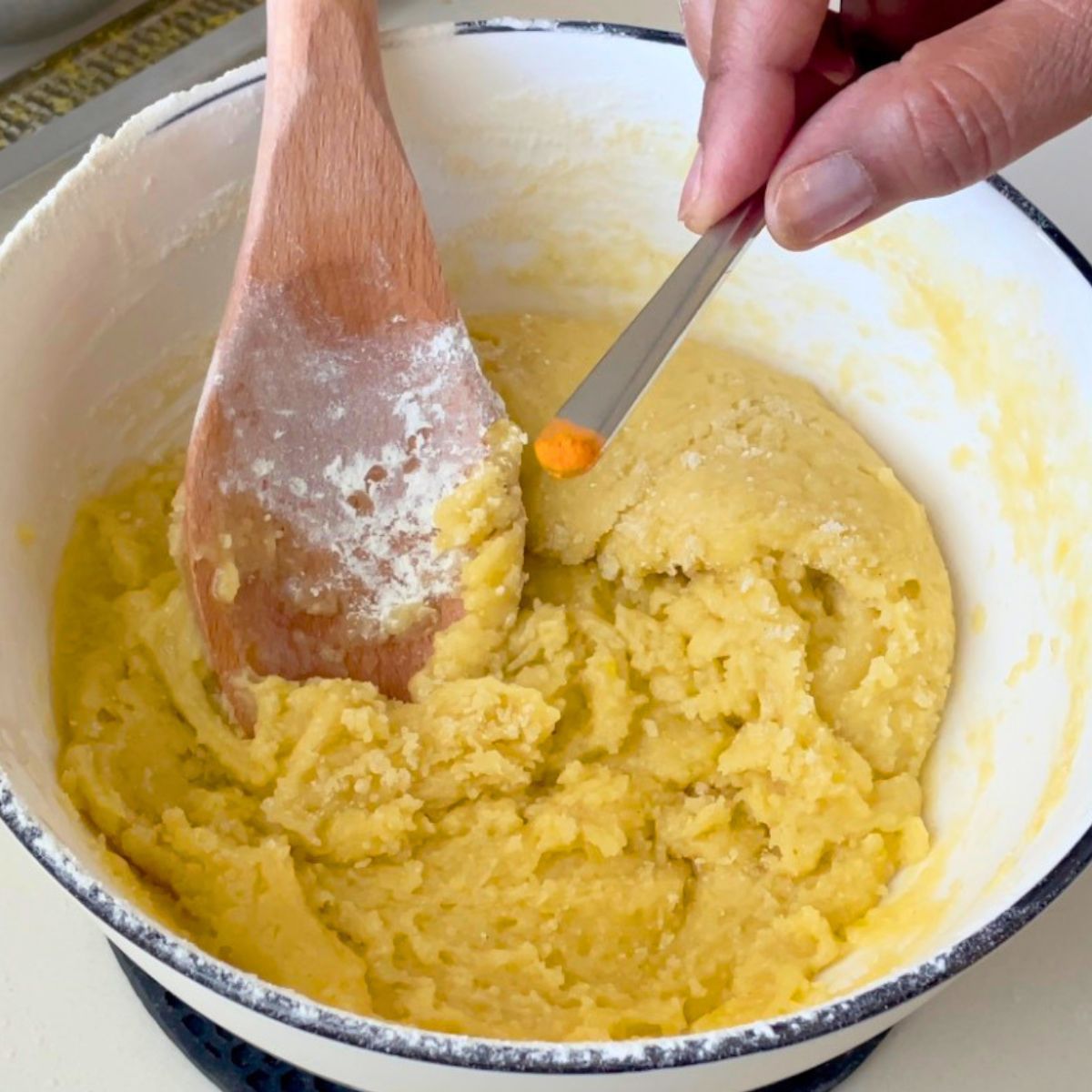 A white bowl with lemon cookie dough.