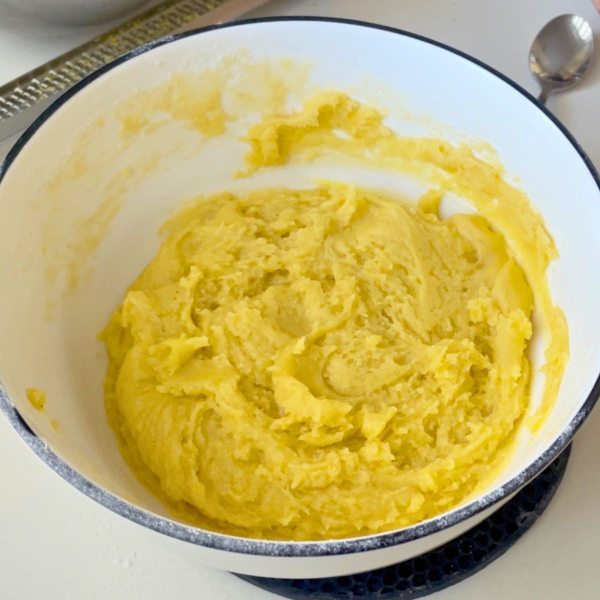 A white bowl with lemon crinkle cookie dough.