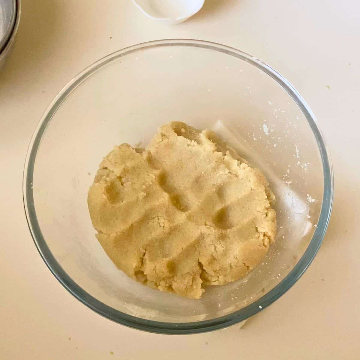 Just mixed almond cookies in a glass bowl.