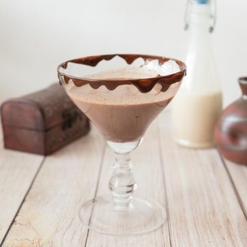 A glass of Baileys chocolate martini on a table.